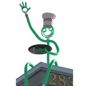 Green tube chef sculpture waving and holding tray, sitting on rooftop