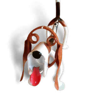 Basset hound metal sculpture with long ears, red tongue, and white and brown finish