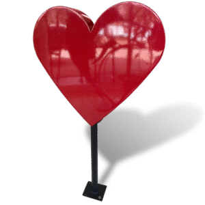 Large glossy red heart sculpture on a black pedestal base